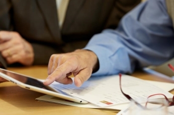 Financial Advisor showing client information on a tablet